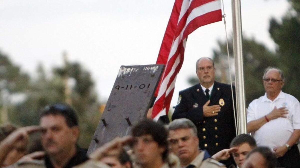 
Father Angelo Pappas (left), chaplain for the Myrtle Beach Fire Department, and Mayor John Rhodes in the 9/11 Unity Memorial of Myrtle Beach at Broadway at the Beach.
