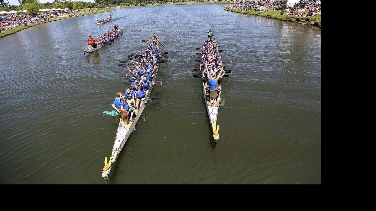 
Boats pass the finish line in the 2014 Dragon Boat Festival races benefiting Ground Zero at The Market Common in Myrtle Beach. Nearly 2,000 people participated in the sixth annual festival for Ground Zero, a Christian youth ministry. 
