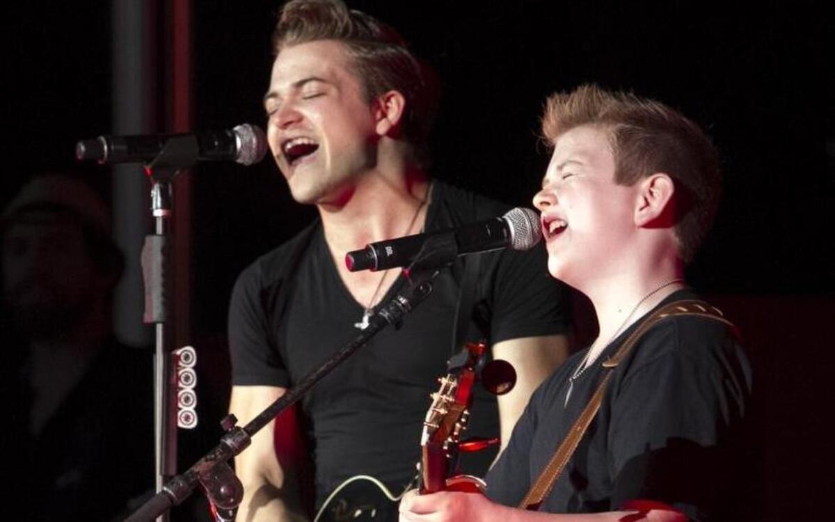 
Hunter Hayes plays and sings with local performer and impersonator Landon Wall, age 11, at Carolina Country Music Fest. "I kept pinching myself wondering if it was a dream," said Wall after meeting Hayes on his tour bus prior to the event. 
