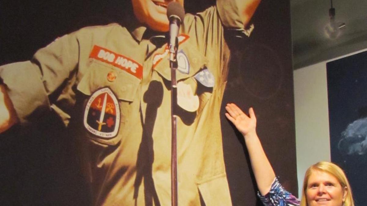 Jenean Todd, executive director of the North Myrtle Beach Area Historical Museum, stands next to one of the gigantic posters in the Bob Hope, An American Treasure exhibit, which runs through Sept. 18. “It’s impressive to see someone do so much for so many,” Todd said.