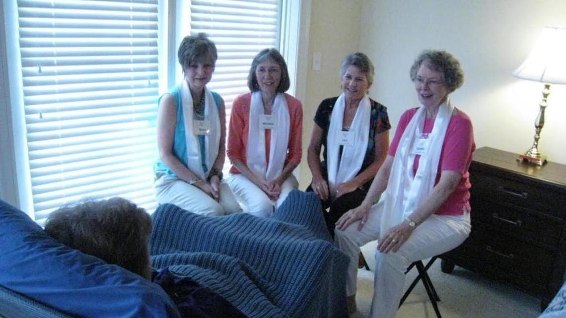 The Long Bay Threshold Singers, who give their time in groups of three or four by singing lullabies at bedside for people at the end of their lives, rehearse with a colleague, Linda Eichenbaum, in the chair in the forefront. From left: Diana Bachand, Melodee Koska, Lani Busbin, and Cynthia Dyer, director. The group will have its first-ever, whole-choir concert at 3 p.m. Sunday at Trinity Presbyterian Church, 2061 Glenns Bay Road, west of Surfside Beach, for free, also to illustrate the mission that their voices carry.