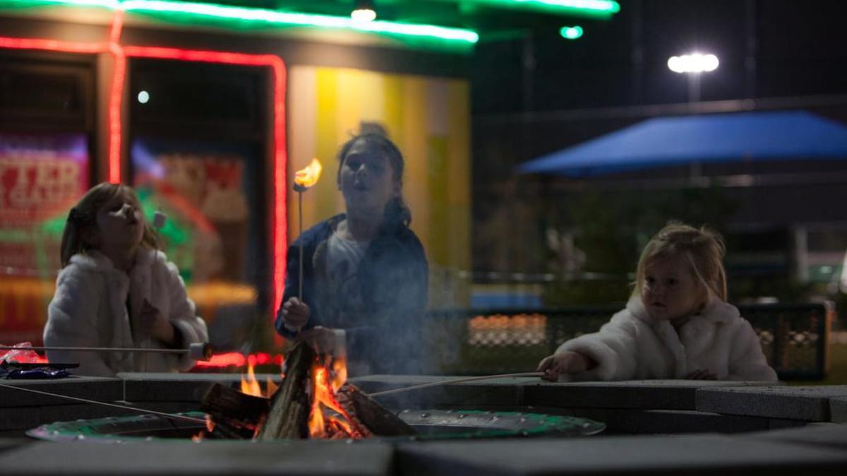 Keeley Nugent (from left), Peyton Stell and Harper Nugent roast marshmallows around a fire pit at the “Christmas Wonderland” lights and festival, open nightly through Dec. 31 at the North Myrtle Beach Park & Sports Complex, at S.C. 90 and Robert Edge Parkway.