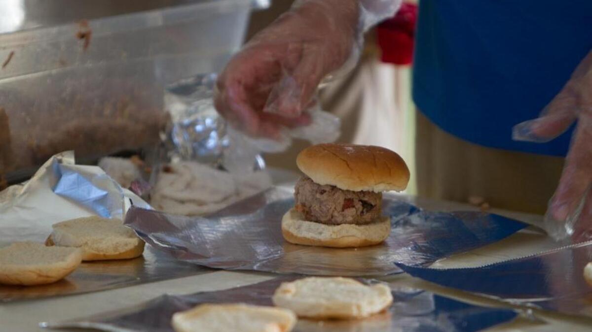 
The BBQ production line at work under the big tent at the Beach, Boogie & BBQ Festival.
