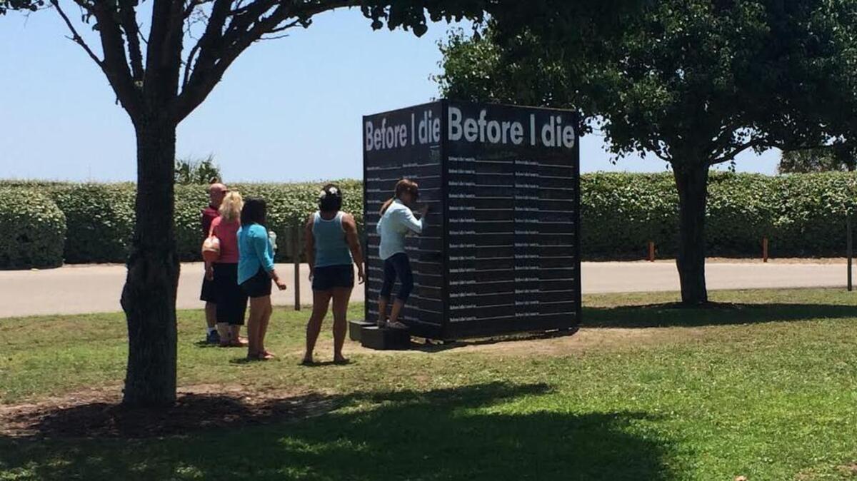 
Some passers-by fill in their answers at the “Before I Die” interactive wall, open around the clock through Sept. 29 at the Franklin G. Burroughs-Simeon B. Chapin Art Museum in Myrtle Beach.
