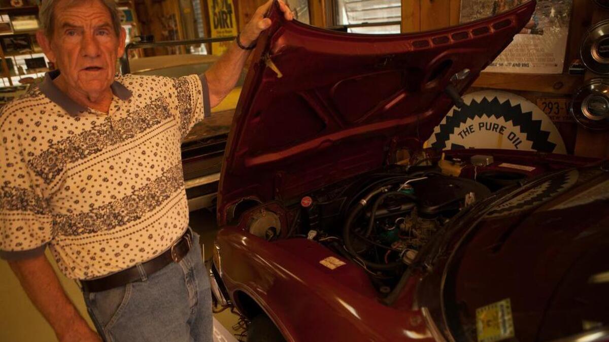 Paul Cummings lifts the hood on an AMC Gremlin, at Wheels of Yesteryear, his classic cars museum just off U.S. 501, near Tanger Outlets, which showcases more than 50 classic cars and myriad memorabilia from a bygone era.
