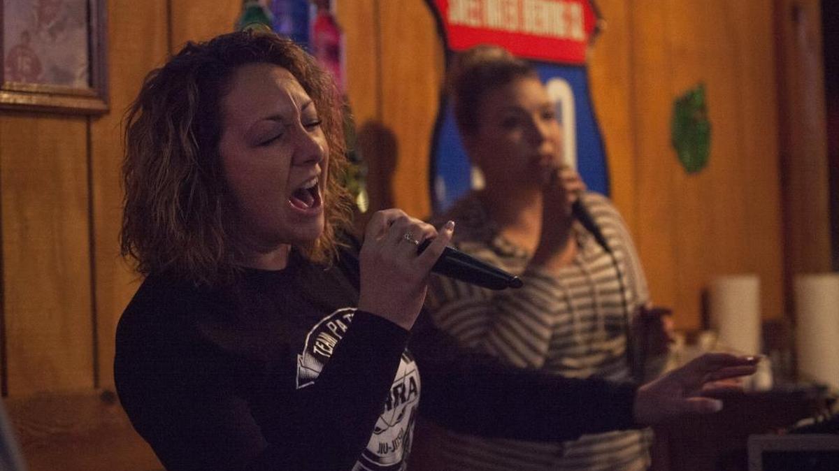Kacey Wagner (L) of Carolina Forest performs with DJ Joanna Ward Saturday at Murphy’s Law in Carolina Forest during karaoke night at the bar. The popularity of karaoke has climbed in the last few years mainly due to the American Idol series which is launching its final season this week.