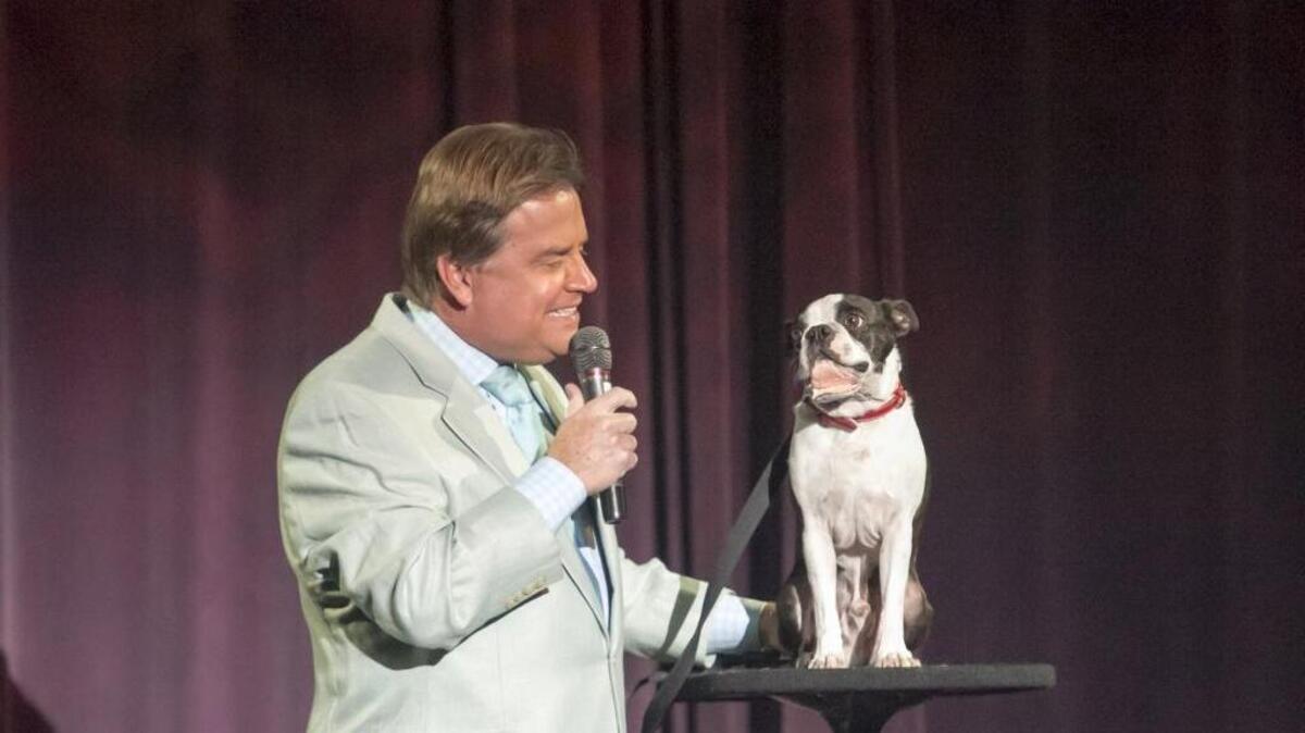 
Todd Oliver, a ventriloquist, with his “talking dog,” a Boston Terrier name Irving at the Alabama Theatre.
