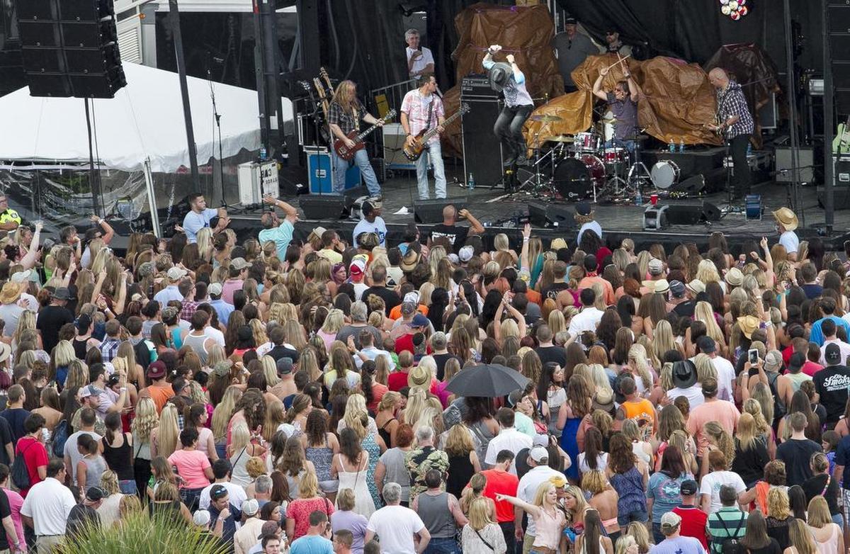 Darrell Harwood jumps for the crowd at the Carolina Country Music Fest. The Carolina Country Music Fest Kick-Off concert series started Thursday night. Scattered showers did not hinder the festivities for the thousands that came to enjoy the first night of the festival. Thursday’s event included Darrell Harwood, The Bobby Ray Little Band, D.J. Silver and Sam Hunt on the Jack Daniels Stage.