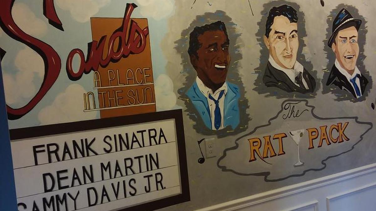 A Rat Pack mural encompasses four walls in the hallway of Joe Arditi’s house, located in The Sanctuary at Withers Preserve in The Market Common.