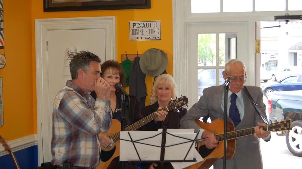 “Banana” Jack Murphy (from left) lends his chops through a harmonica as members of The Principles – Linda Dell, Pauline Honeycutt and Winfred Shelton – perform during a “Down at the Barbershop” live remote broadcast from the Loris Barber Shop, 4011 Meeting St. The weekly show, with a bevy of local musicians invited to take part, airs 10 a.m.-noon Fridays on WLSC-AM 1240 “Tiger Radio.”