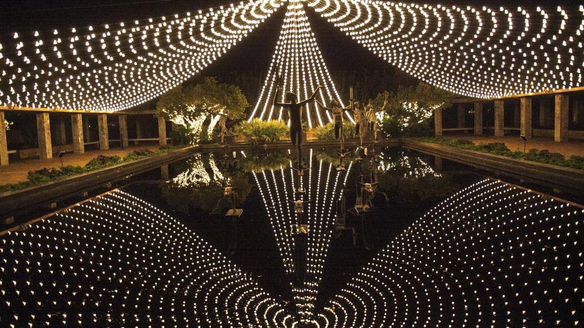 “Nights of a Thousand Candles,” lights are reflected in a pool on Dec. 8, 2016.