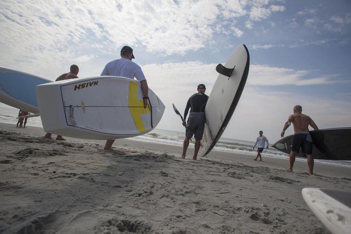 Saturday participants in the advanced paddleboard races wait for the start of a race during The Salt Games in downtown Myrtle Beach in 2014. The Salt Games is a two-day beach event featuring live sporting competitions including a pro/am surfing tournament, pro volleyball, the Crossfit Updog Summer Games, paddleboard racing, and more. Proceeds from the Salt Games benefit the Grand Strand Chapter of the Surfrider Foundation. File photo.