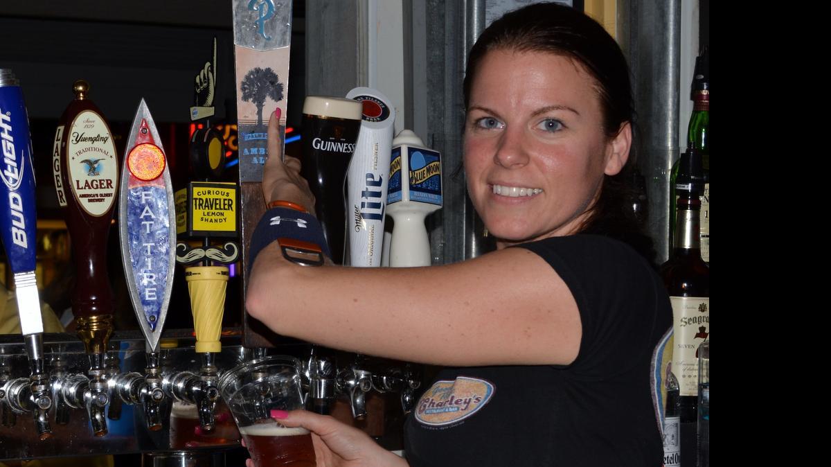 
Jayme White tends bar at Good Time Charley’s. By Derrick Bracey, for The Surge.

