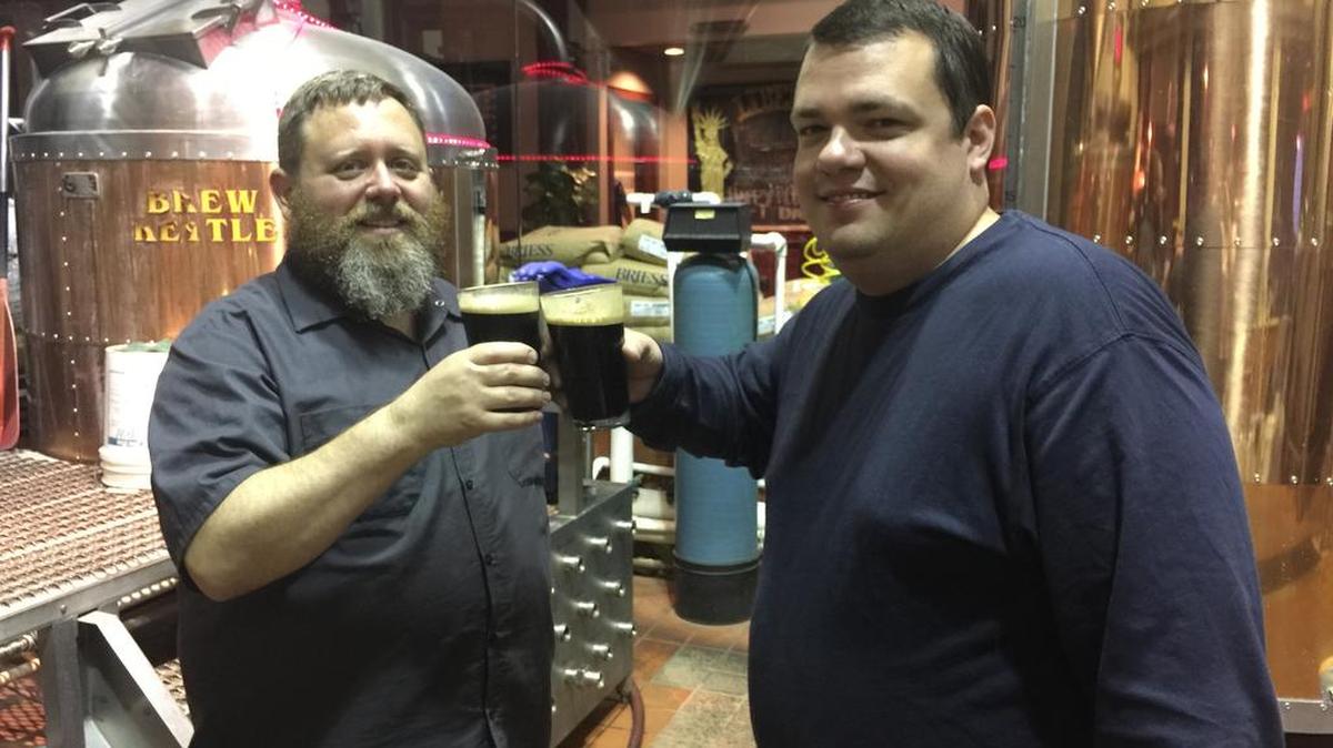 Jilly Garner, Head Brewer at New South Brewing and Mike Silvernale, Head Brewer at Liberty sample Oreo Speedwagon imperial milk stout at New South Brewing in Myrtle Beach. Photo by Kristen West for The Surge.