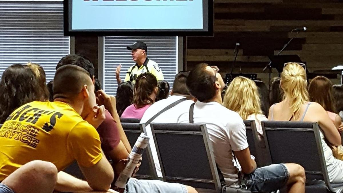 A J1 student-worker loses interest while Officer Allen gives his safety presentation at the orientation. Photo by Derrick Bracey for The Surge.
