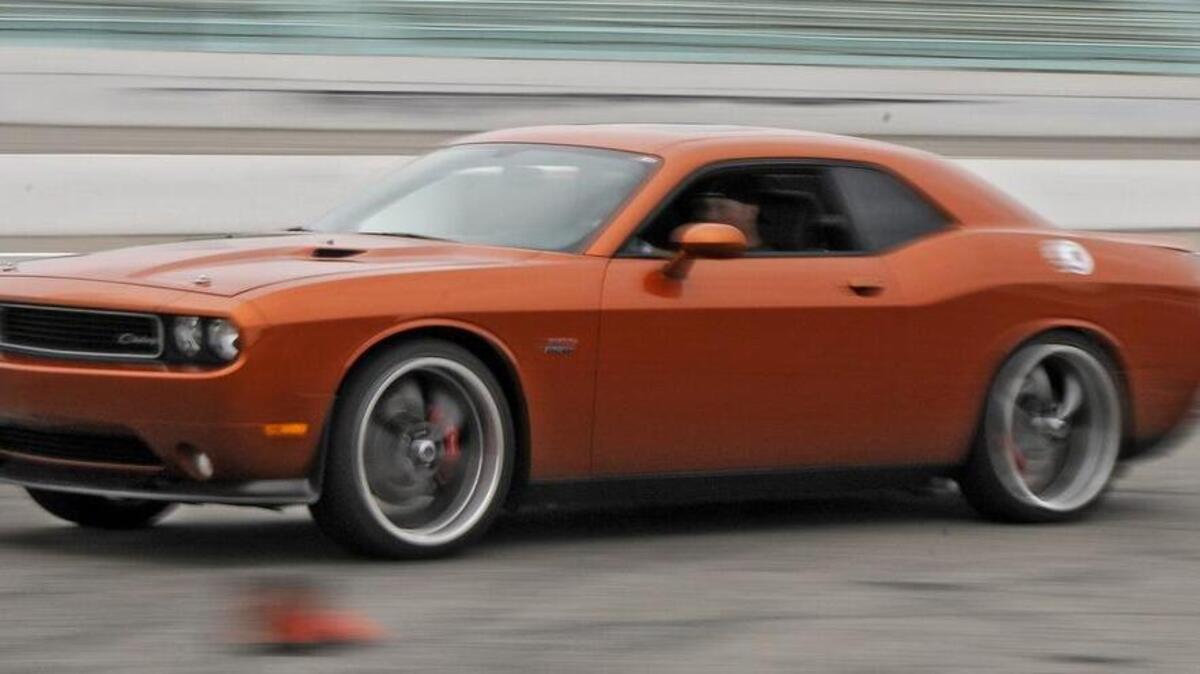 
Darrell Cagle of Asheboro, NC drives his 2011 Toxic Orange Dodge Challenge SRT-8 around the autocross course at Myrtle Beach Speedway during the Mopar Week Race Challenge at Myrtle Beach Speedway. File photo.
