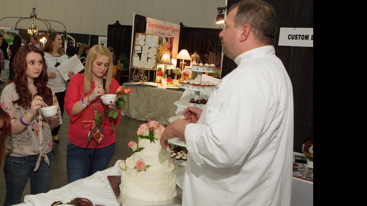 
Exhibitors chat about wedding plans with brides to be. There are plenty of ways to wedding plan on a budget. File photo.
