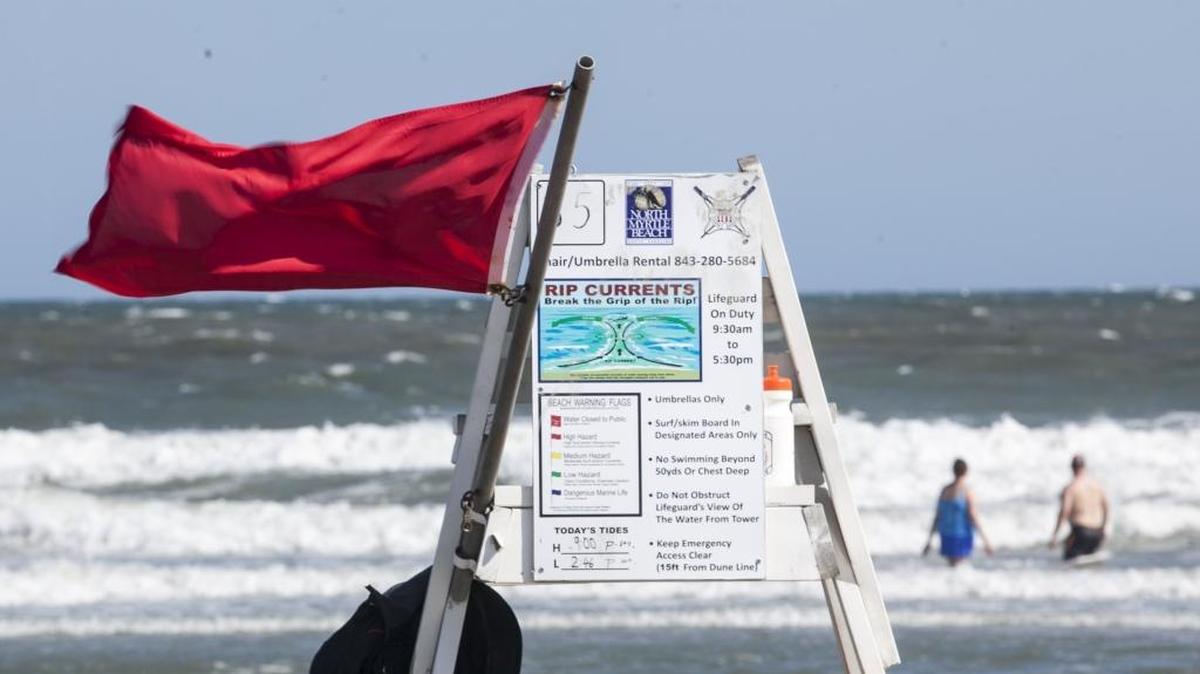 A red flag flies from a lifeguard stand in this file photo from a shark bite in North Myrtle Beach.