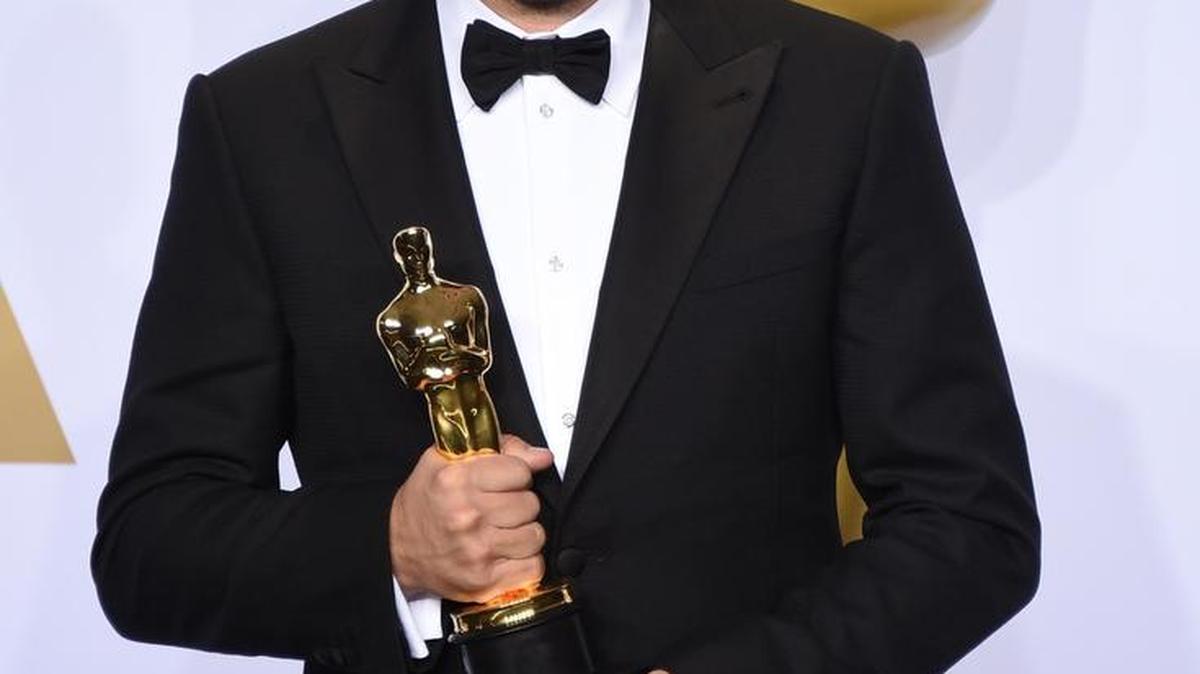 Leonardo DiCaprio poses in the press room with the award for best actor in a leading role for “The Revenant” at the Oscars on Sunday, Feb. 28, 2016, at the Dolby Theatre in Los Angeles.
