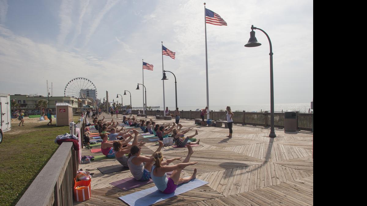 
Shanti beach yoga participants take part on Saturday in The Salt Games in downtown Myrtle Beach in 2014. File photo.
