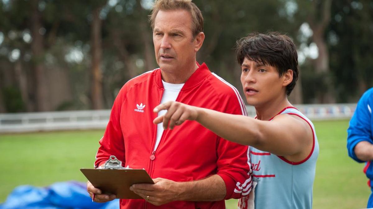 
In this image released by Disney, Kevin Costner (foreground left) embraces Carlos Pratts in a scene from “McFarland, USA.”
