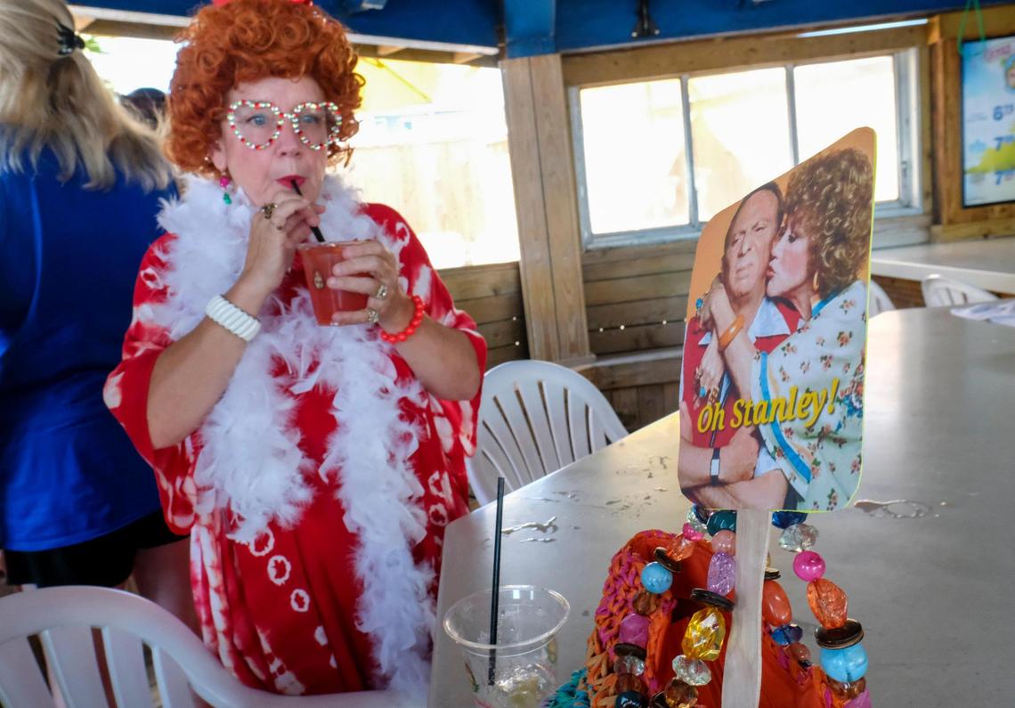 Rhonda Cauchois is one of the many members of the Grand Strand chapter of the International Order of the Mrs. Ropers, a club where participants dress as Helen Roper from the late 1970s to 1980s TV series “Three’s Company.” The members went on a pub crawl with Tito’s Trolley Company in Myrtle Beach on Saturday. The group visited several area bars taking pictures and joking with other patrons. July 18, 2025.