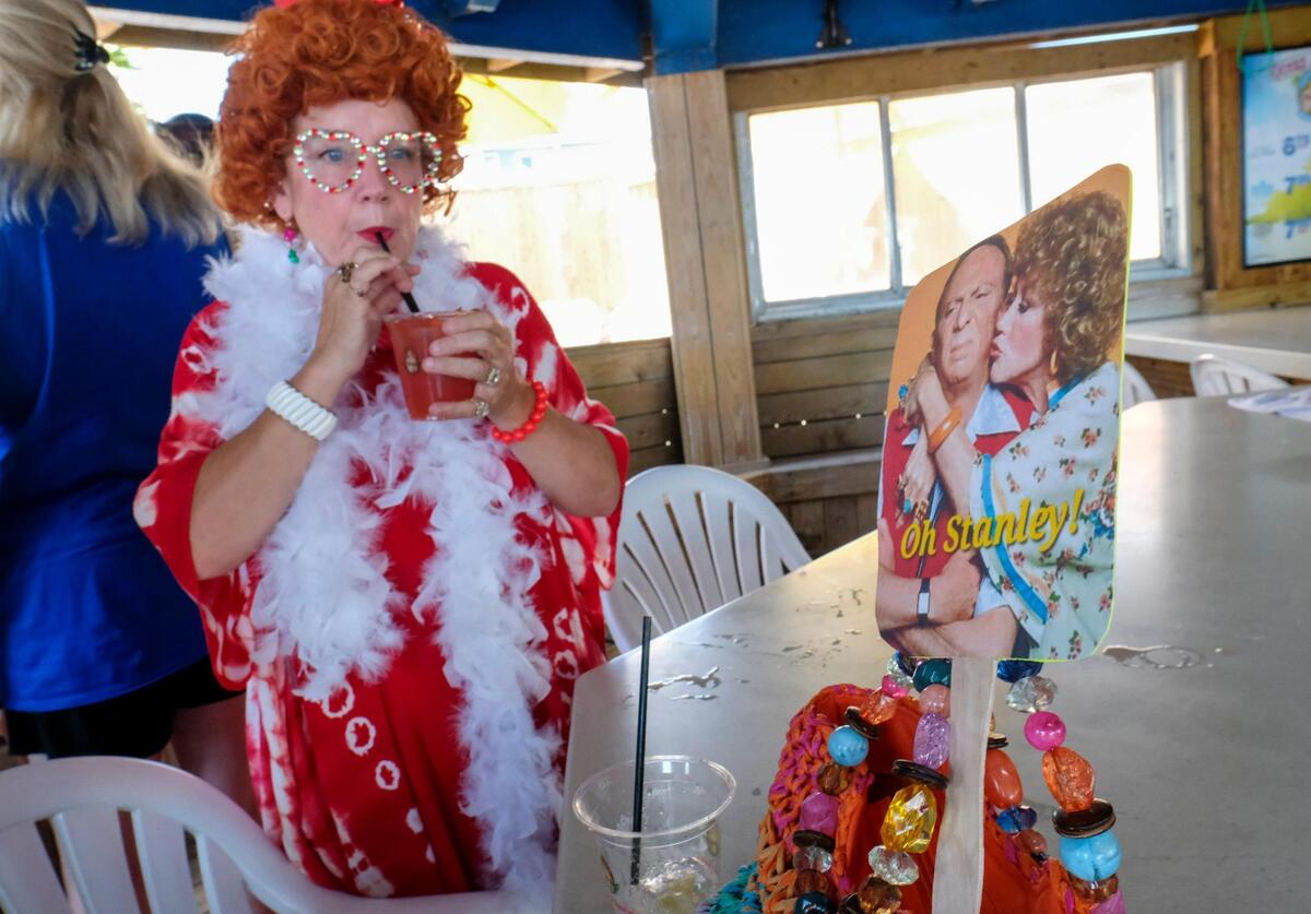 Rhonda Cauchois is one of the many members of the Grand Strand chapter of the International Order of the Mrs. Ropers, a club where participants dress as Helen Roper from the late 1970s to 1980s TV series “Three’s Company.” The members went on a pub crawl with Tito’s Trolley Company in Myrtle Beach on Saturday. The group visited several area bars taking pictures and joking with other patrons. July 18, 2025.