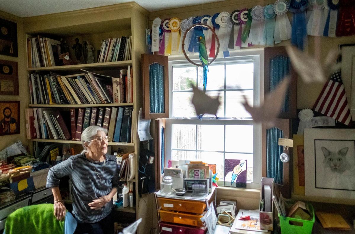 Dixie Dugan, looks at some of her award ribbons hung in her home studio Myrtle Beach, S.C. Dugan’s art predominantly features origami paper works and watercolor painting. Dugan, age 95, founded the Waccamaw Art Guild which is now celebrating it’s 50th year. November 9, 2022.