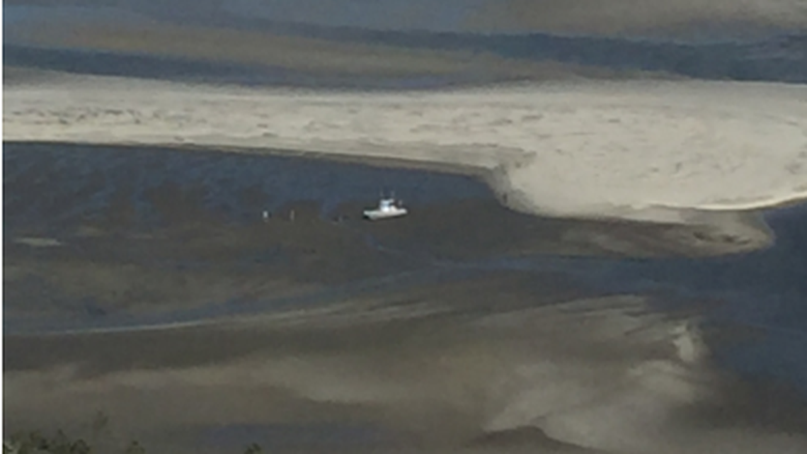 Three teenagers had to be rescued from a boat off Georgia Wednesday after it was found high and dry in low tied, according to the U.S. Coast Guard.