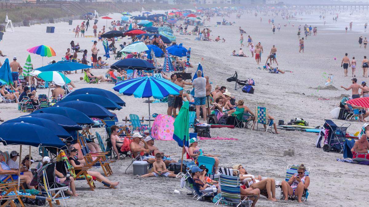 Beachgoers pack the beach in the Cherry Grove section of North Myrtle Beach during Memorial Day weekend 2021. On boats, beaches and the boulevards, tourists and residents enjoy the first days of the summer season on the Grand Strand during Memorial Day weekend. May 29, 2021.