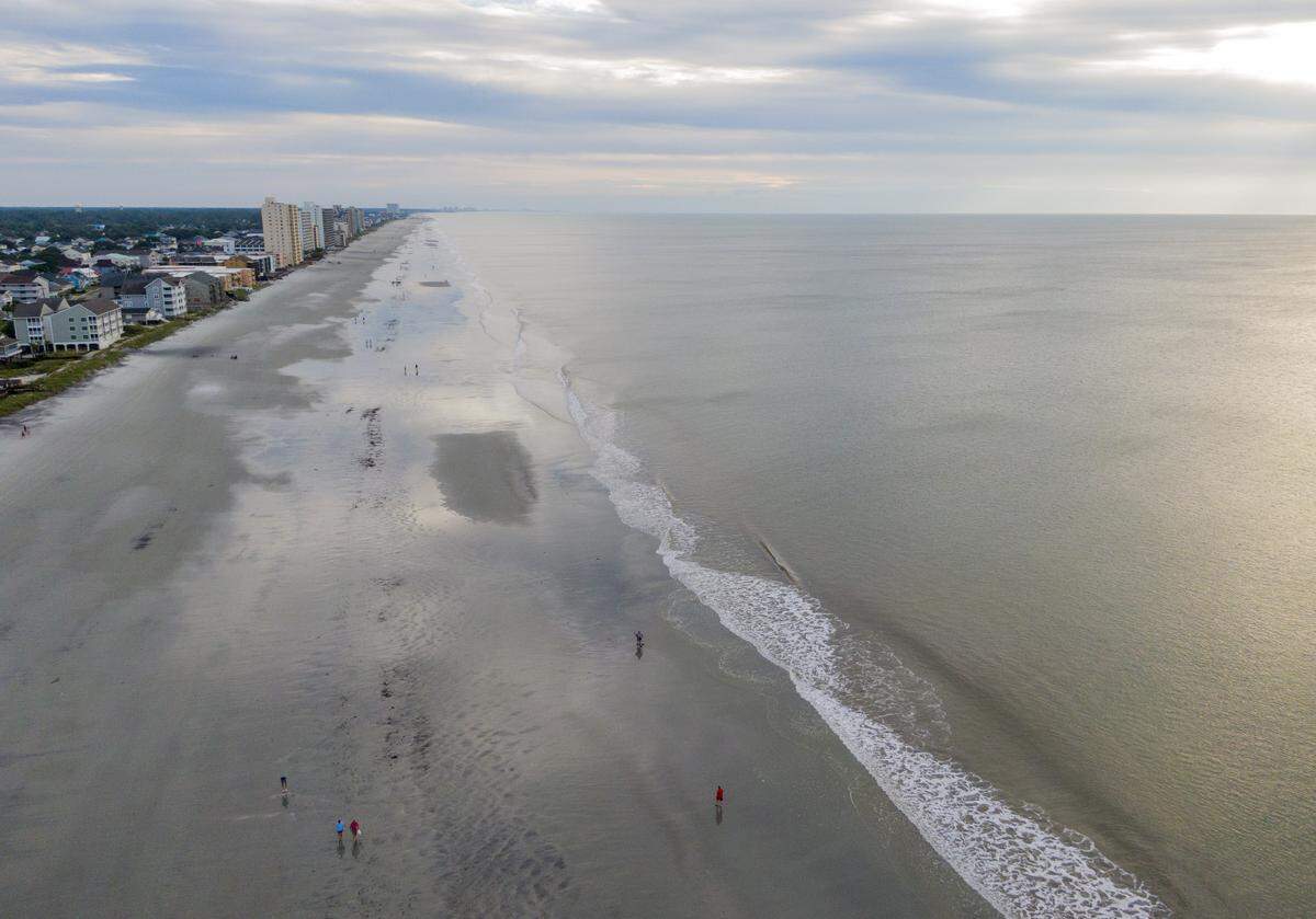 Garden City residents take to the beach after the brunt of the effects of Hurricane Dorian Friday morning.
