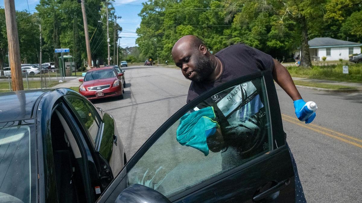 Ross Brown, washing his car on Canal Street, talks about his concerns with a proposal for a dorm like housing complex to be built at the corner of Mr. Joe White Avenue and Grissom Parkway in the historically Black Harlem community. April 13, 2023.