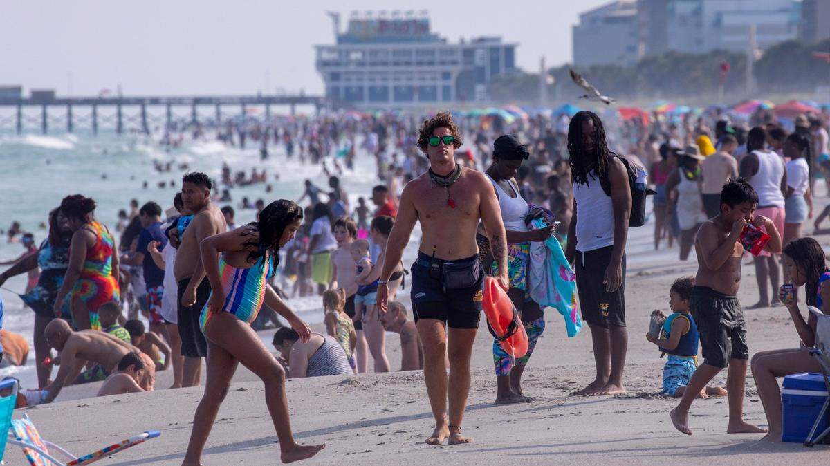 A lifeguard patrols the Myrtle Beach strand on Saturday. Despite a heatwave, crowds arrive in Myrtle Beach for the July 4th weekend on Saturday. Tourists packed beaches, cruised the boulevard and enjoyed fireworks at the Myrtle Beach Pelicans baseball game. July 1, 2023.