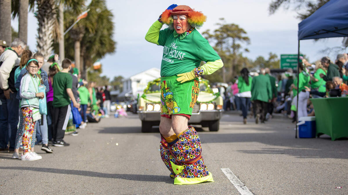 Members of the Grill House Queens move along Main Street in North Myrtle Beach during the St. Patrick’s Day parade.