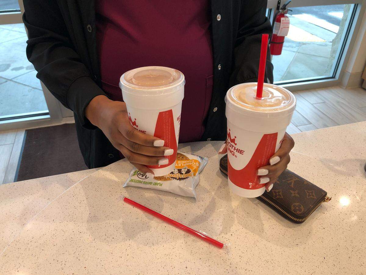 A customer shows off the Peanut Power Plus and Mocha Yogurt Delight smoothies. Smoothie King opened their second Myrtle Beach-area location in Coventry Marketplace on February 5. The drive-thru, near Socastee and Market Common, features a menu of over 80 smoothies. February 9, 2023.