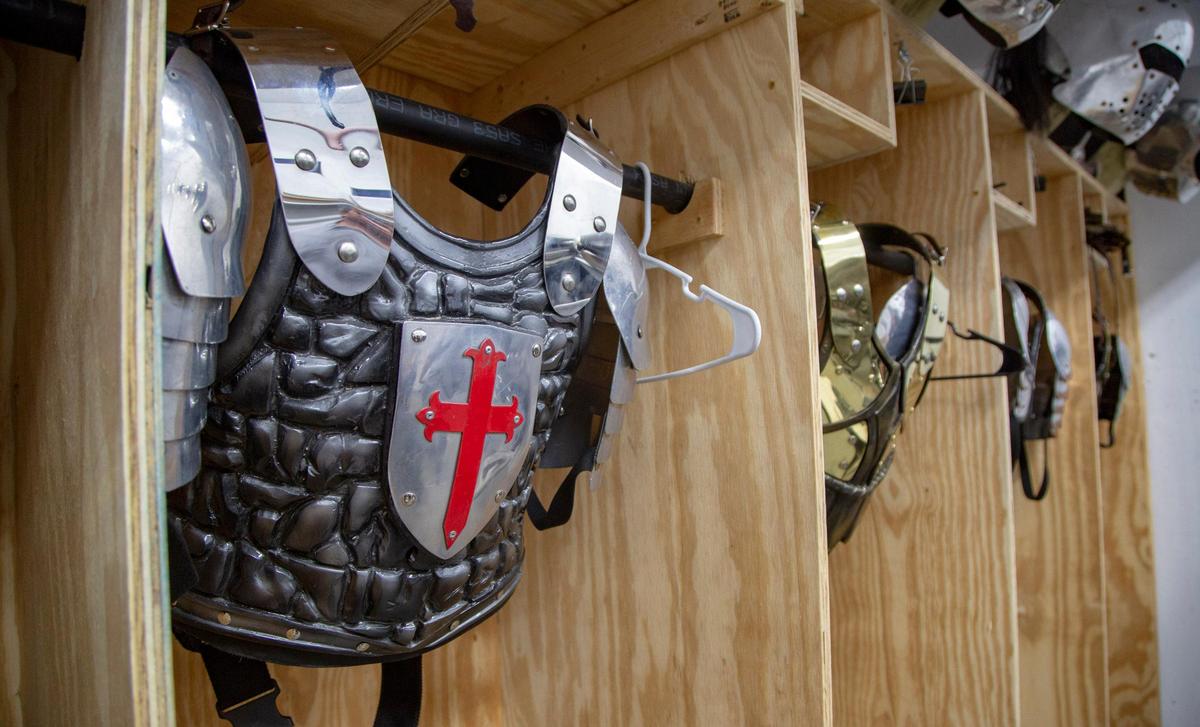 Combat armor hangs in stalls along the wall backstage at Medieval Times in Myrtle Beach.