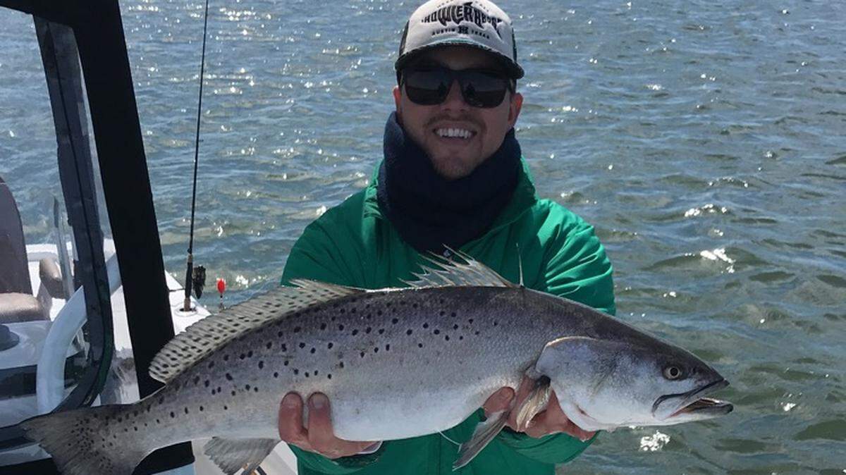 Capt. Landon Brice shows off a 30-inch spotted seatrout caught while fishing with Capt. Chris Ossman of Captain Smiley Charters in Little River.