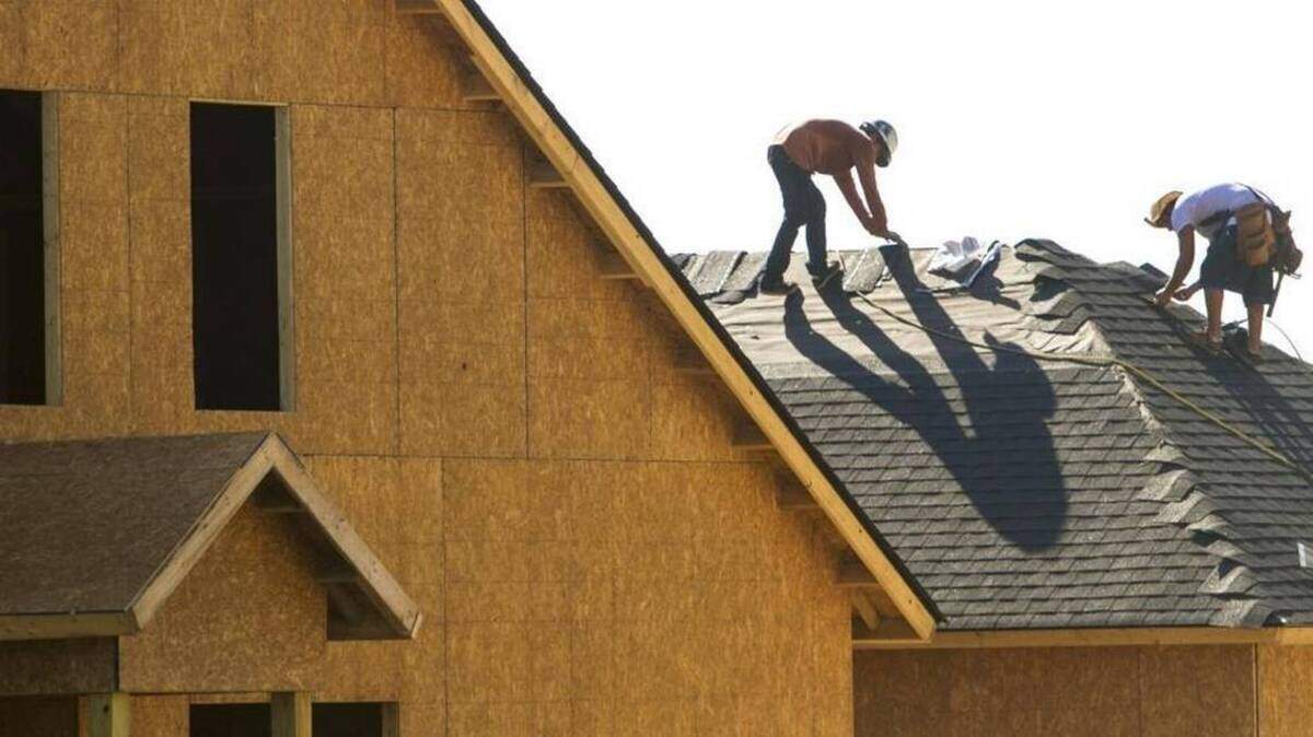 Contractors work on the roof of one of the many new homes being built in the Emmens Preserve in The Market Common area of Myrtle Beach.