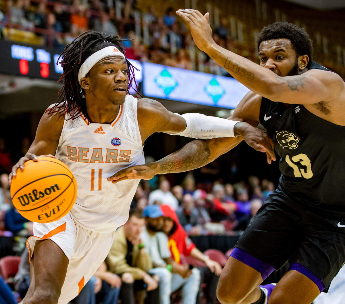 Mercer sophomore guard Jovan Tucker drives to the net against West Carolina junior forward Marlow Gilmore Friday night during the SoCOn Ingle Basketball Championships at the Harrah’s Cherokee Center in Asheville, N.C.