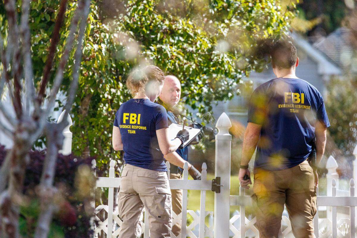 FBI agents searched the home of former Myrtle Beach pastor John Paul Miller on Friday as a crowd, some carrying “Justice for Mica” signs, gathered outside the home to watch. Nov. 1, 2024.