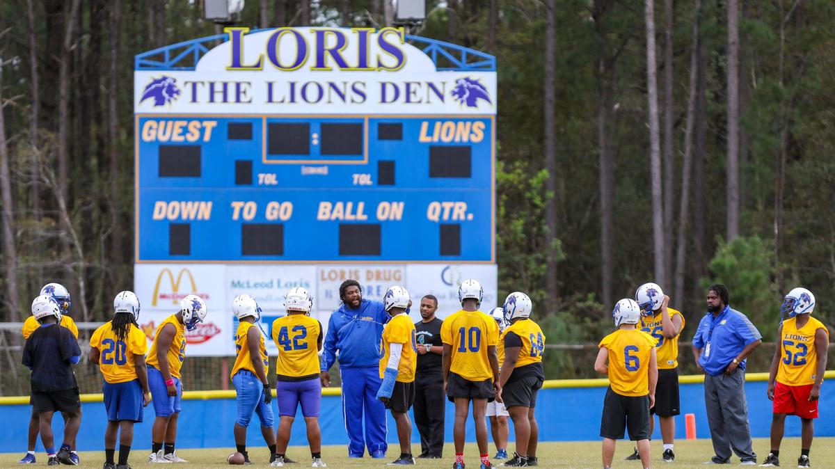 Loris football players listen as assistant coach Adrain Grady calls out a drill during practice Thursday at Heniford Field in Loris.