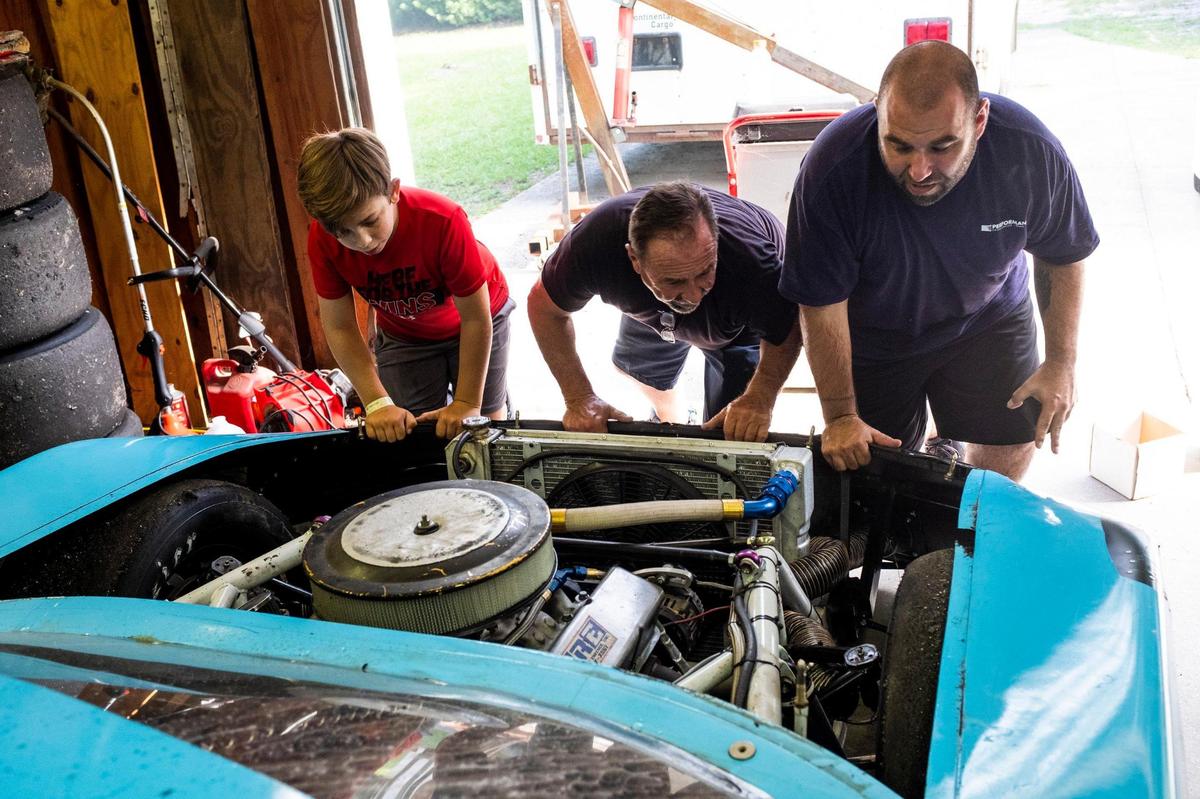 Samie Scarpelli Jr. (center) gets help from his grandson Chase Scarpelli (left) and son Samie Scarpelli III, in setting up his car for his last race at Myrtle Beach Speedway. As the Myrtle Beach Speedway prepares to hold it’s last race, local drivers are readying their cars and reminiscing about their days at the track. August 12, 2020.