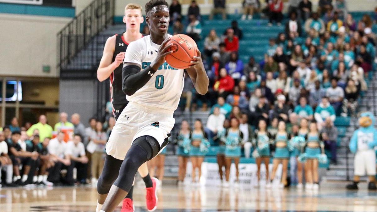Coastal Carolina guard Ebrima Dibba drives to the basket during CCU’s 79-57 win over Utah in the first round of the 2019 Myrtle Beach Invitational college basketball tournament at the HTC Center in Conway. Dibba suffered a season-ending leg injury in the tournament and has returned to the team for the 2020-21 season.