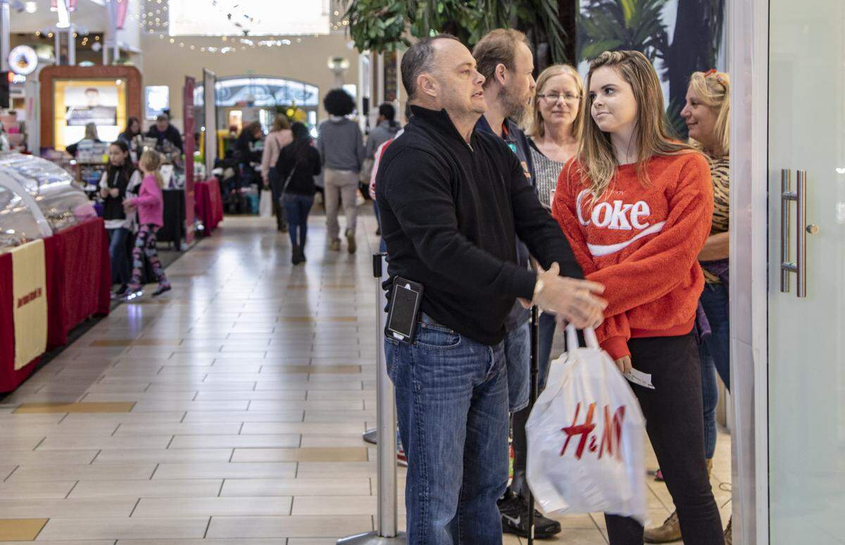 Black Friday shoppers wait in line at Pandora in Coastal Grand Mall in Myrtle Beach Friday.