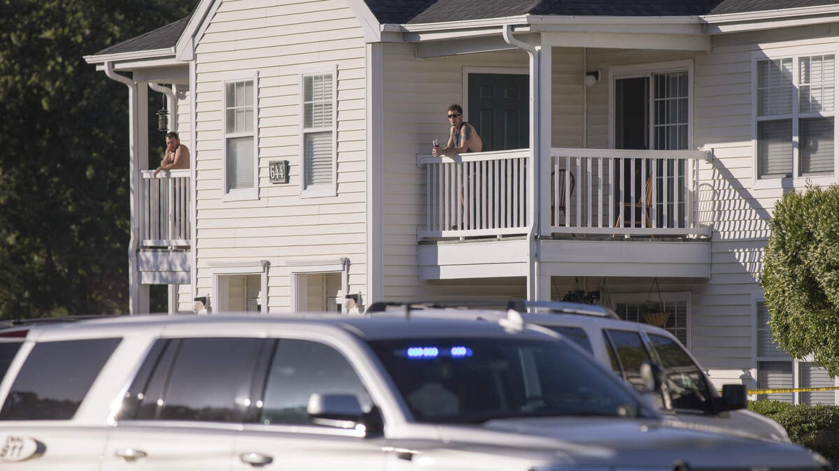 Neighbors watch from porches at the scene of a shooting at Flintlake Apartments. Two people died after a shooting incident at the Flintlake Apartments near Myrtle Beach on Wednesday evening. May 2, 2018.
