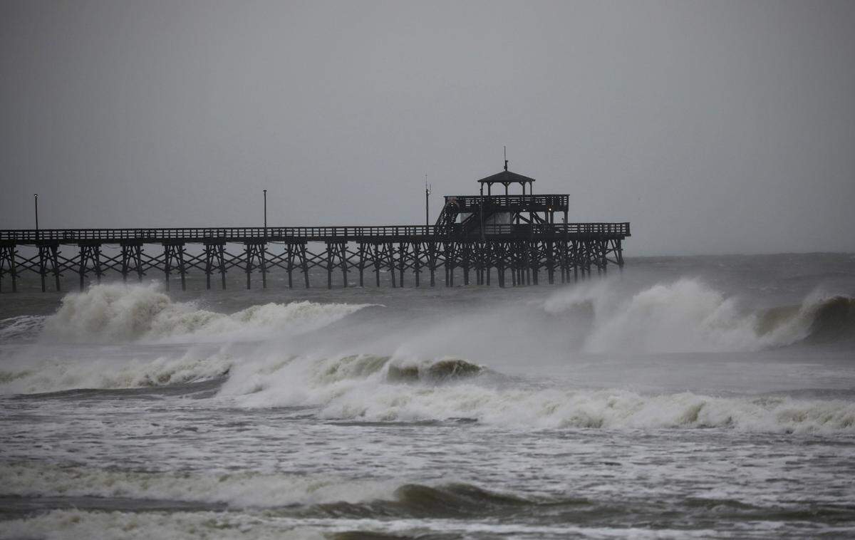 The Cherry Grove Pier Friday, Sept. 30, around 10 a.m. takes wind and waves as Hurricane Ian approaches landfall in South Carolina. This is near where Ian was expected to make landfall. JASON LEE/SUN NEWS
