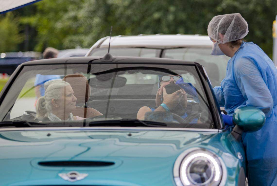 Tidelands Health medical professionals conduct COVID-19 tests Saturday morning as Tidelands Health and DHEC partnered to host a drive-thru COVID-19 testing facility at Pelicans Stadium in Myrtle Beach. Hundreds lined up for the first day of the clinic.