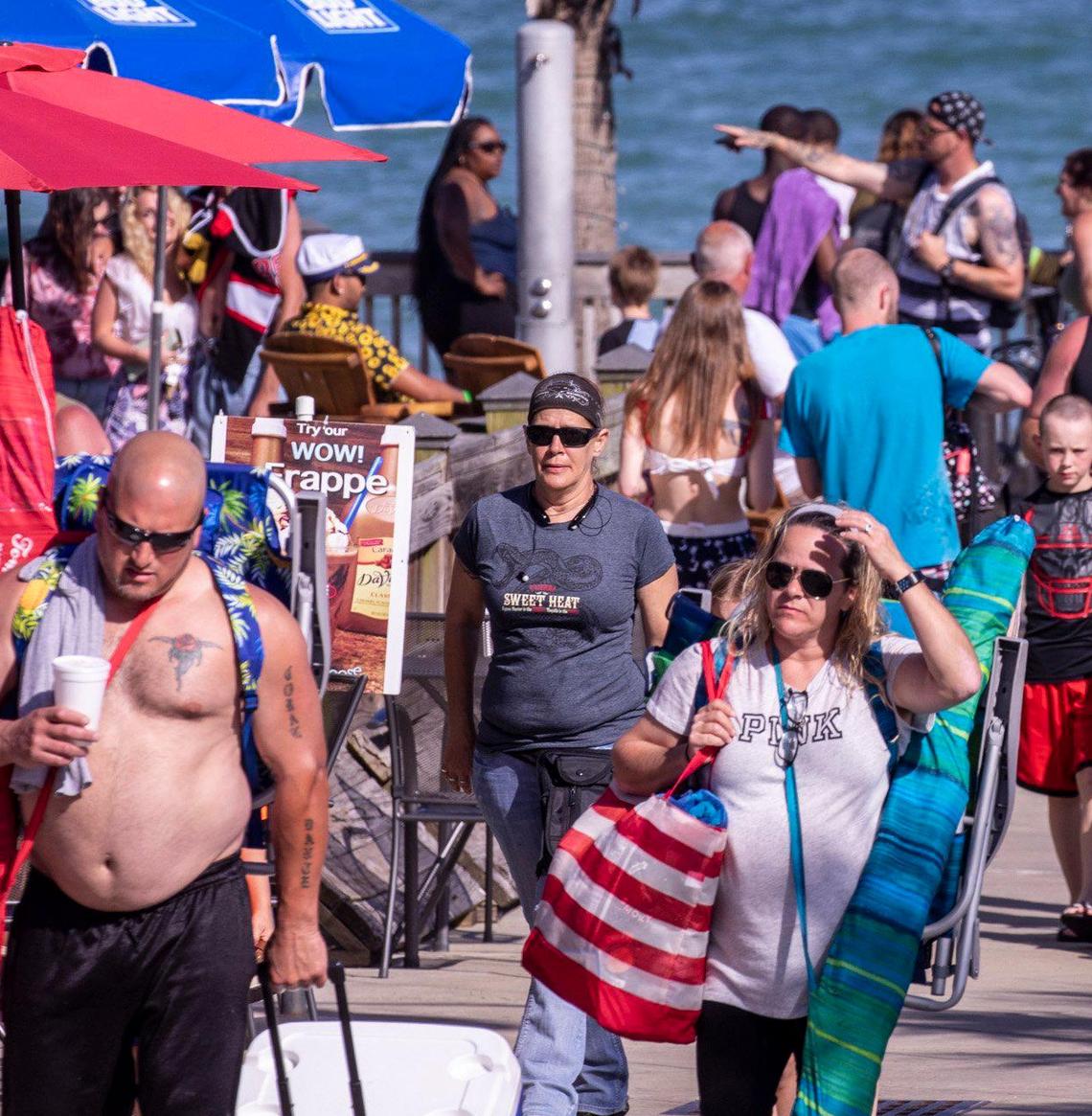 Beach goers and tourists walk the Myrtle Beach boardwalk on Saturday. With hotels, beaches, shopping and restaurants reopening along the Grand Strand, tourist season kicked off this weekend despite coronavirus concerns. May 16, 2020