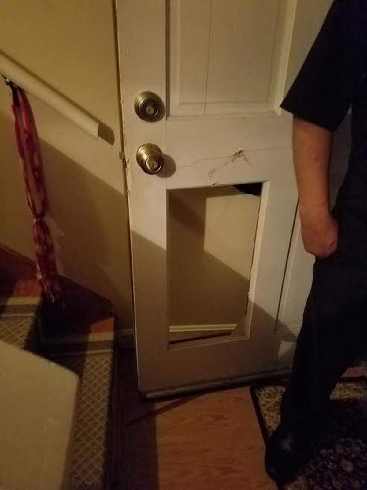 A panel of the door is knocked out after police used a battering ram to force a door open at a 37th Avenue North home on July 25, 2018. The family that lived at the home said the police raided the residence, but the person they were looking for lived at another nearby apartment.