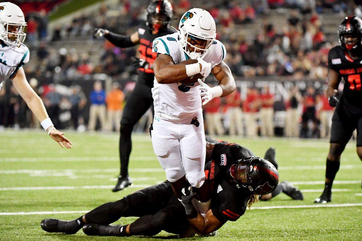 Coastal Carolina running back Shermari Jones (5) runs past Arkansas State defender David Clayton (5) to score a touchdown during the first half of an NCAA college football game Thursday, Oct. 7, 2021, in Jonesboro, Ark. (AP Photo/Michael Woods)